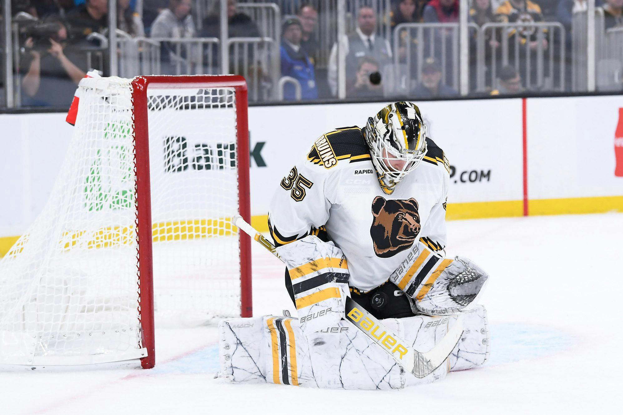 Boston Bruins goaltender Linus Ullmark, left, makes a stop of a