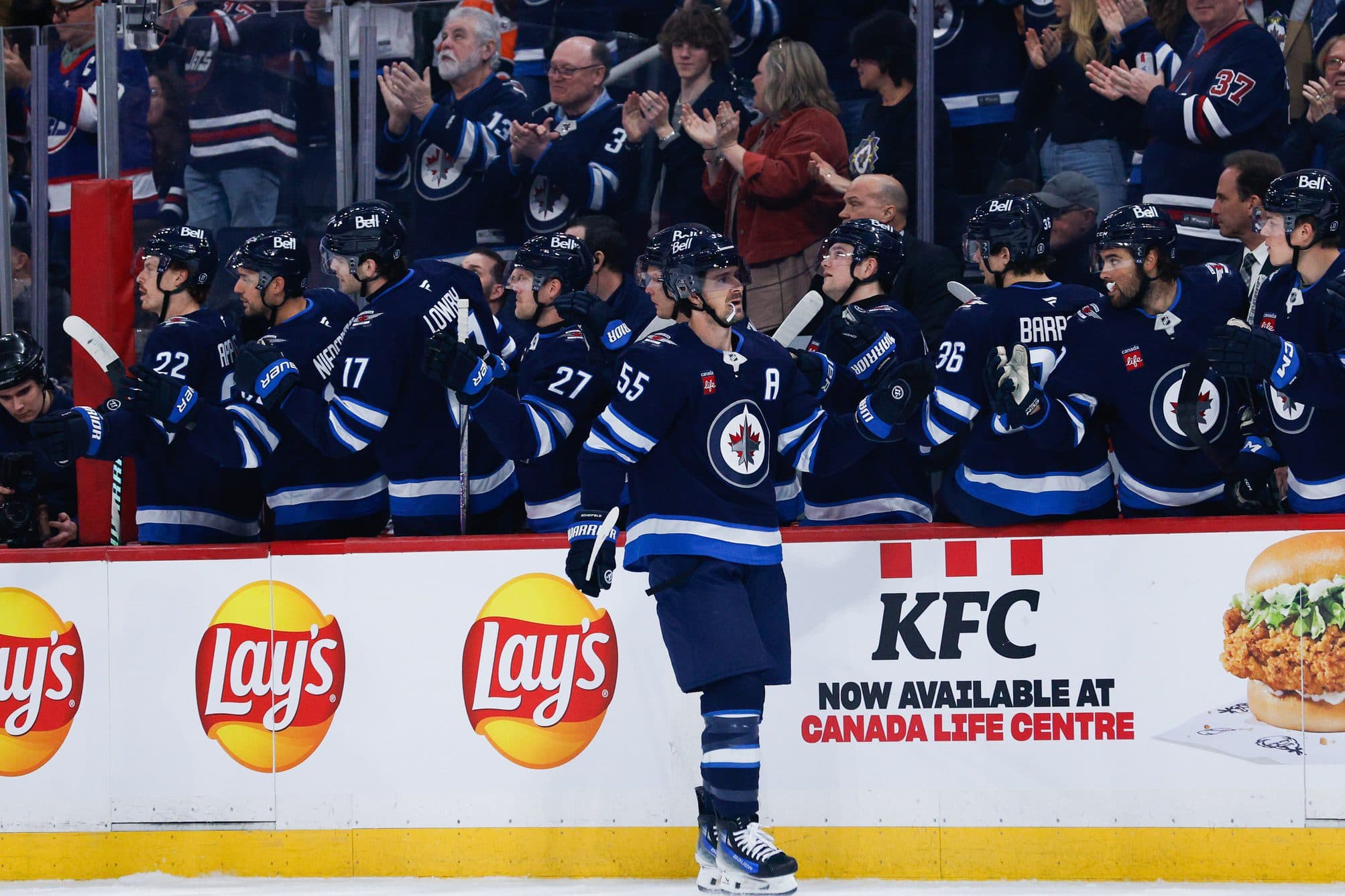 Winnipeg Jets forward Mark Scheifele (55) is congratulated by team mates for scoring a goal against the Philadelphia Flyers during the first period at Canada Life Centre.
