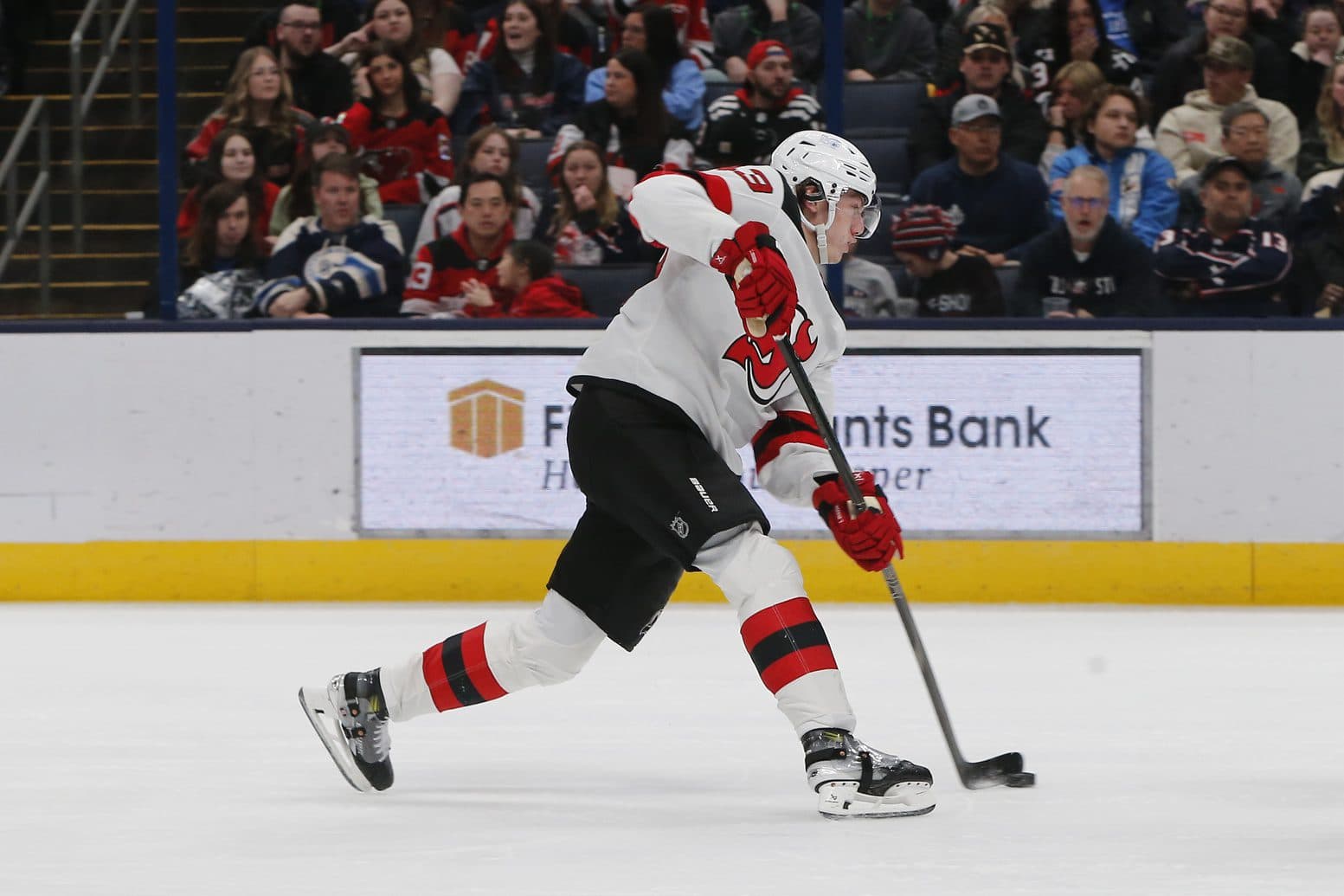 New Jersey Devils defenseman Luke Hughes (43) wrists a shot on goal against the Columbus Blue Jackets during the second period at Nationwide Arena.