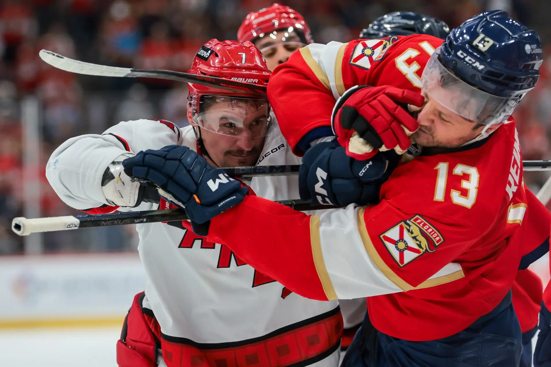 Carolina Hurricanes defenseman Dmitry Orlov (7) hits Florida Panthers center Sam Reinhart (13) at the end of the first period at Amerant Bank Arena.