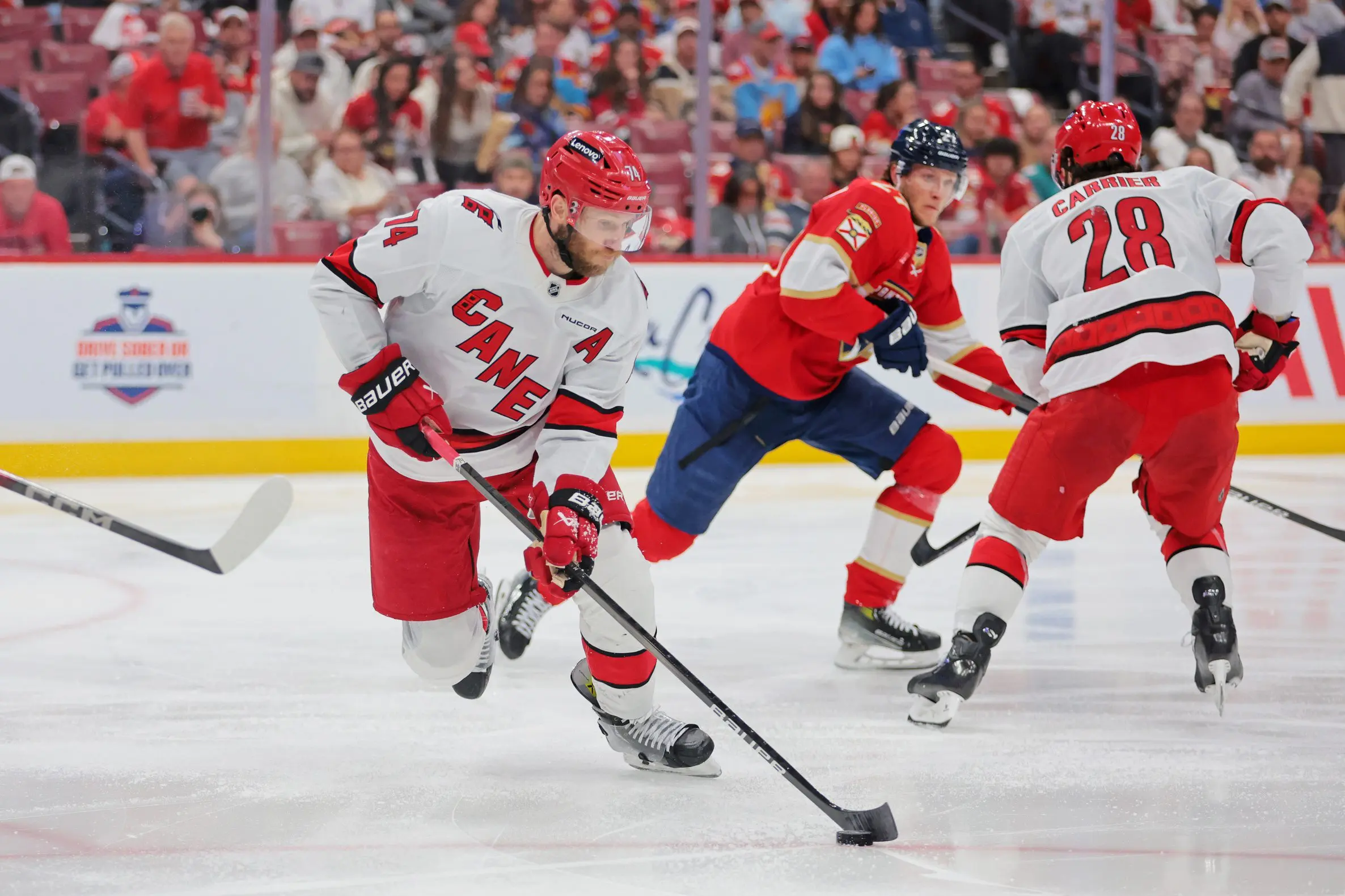 Carolina Hurricanes defenseman Jaccob Slavin (74) moves the puck during the second period against the Florida Panthers in game four of the Eastern Conference Final of the 2025 Stanley Cup Playoffs at Amerant Bank Arena.