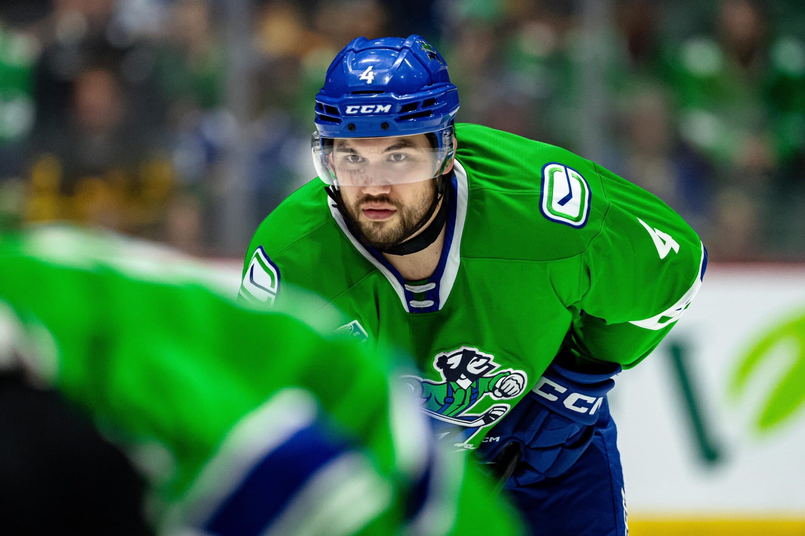 Canucks place defenseman Jett Woo on waivers