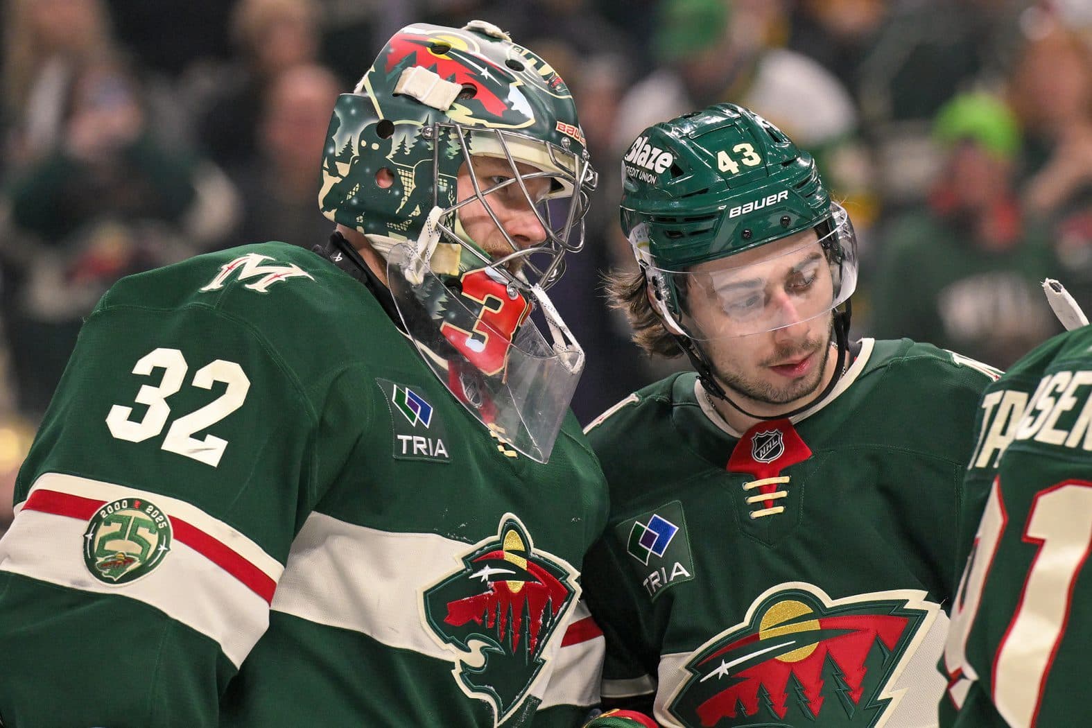 Minnesota Wild goalie Filip Gustavsson (32) and defensemen Quinn Hughes (43) celebrate a victory over the Boston Bruins at Grand Casino Arena.