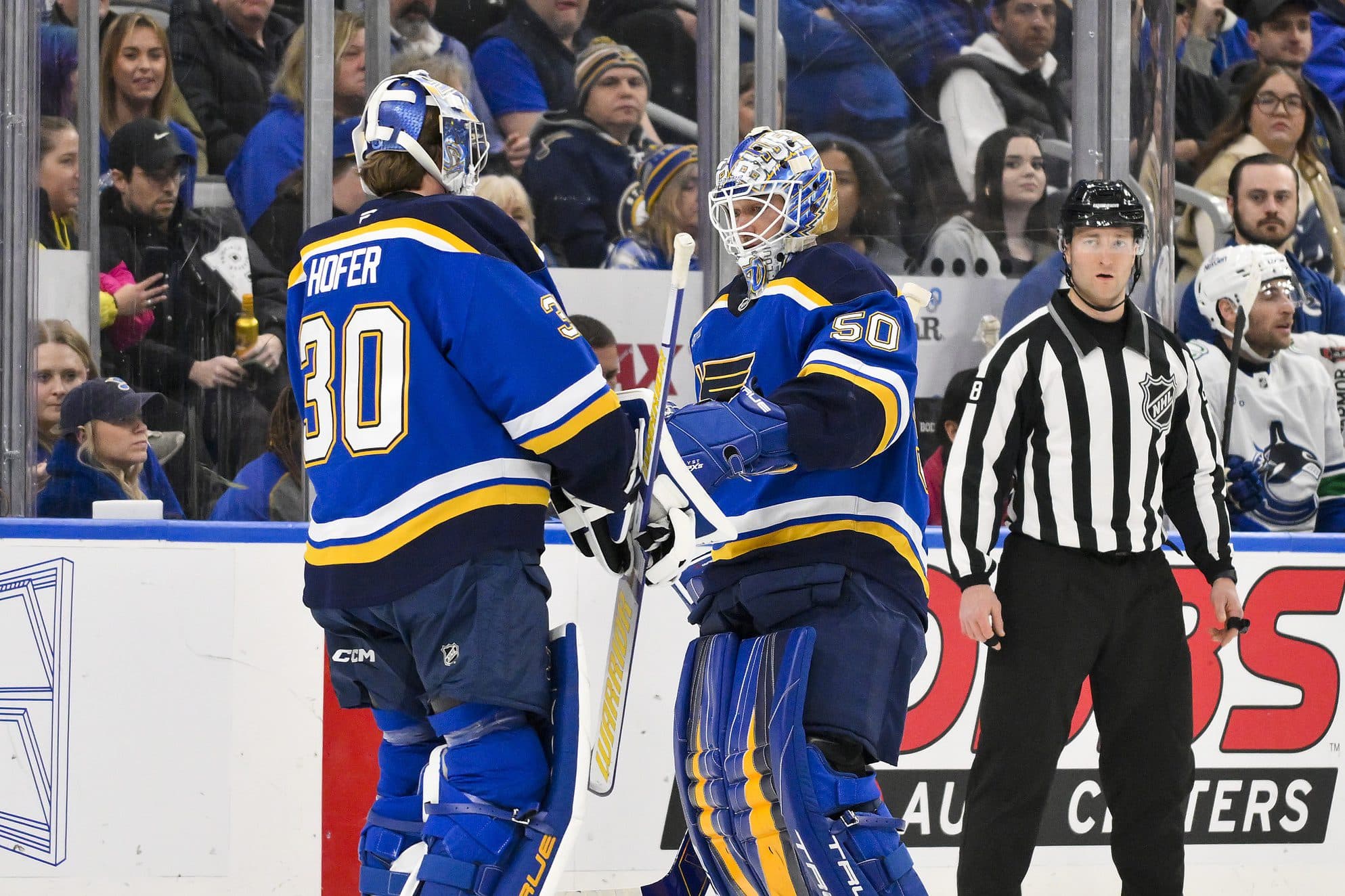 St. Louis Blues goaltender Jordan Binnington (50) is replaced by goaltender Joel Hofer (30) during the second period against the Vancouver Canucks at Enterprise Center.