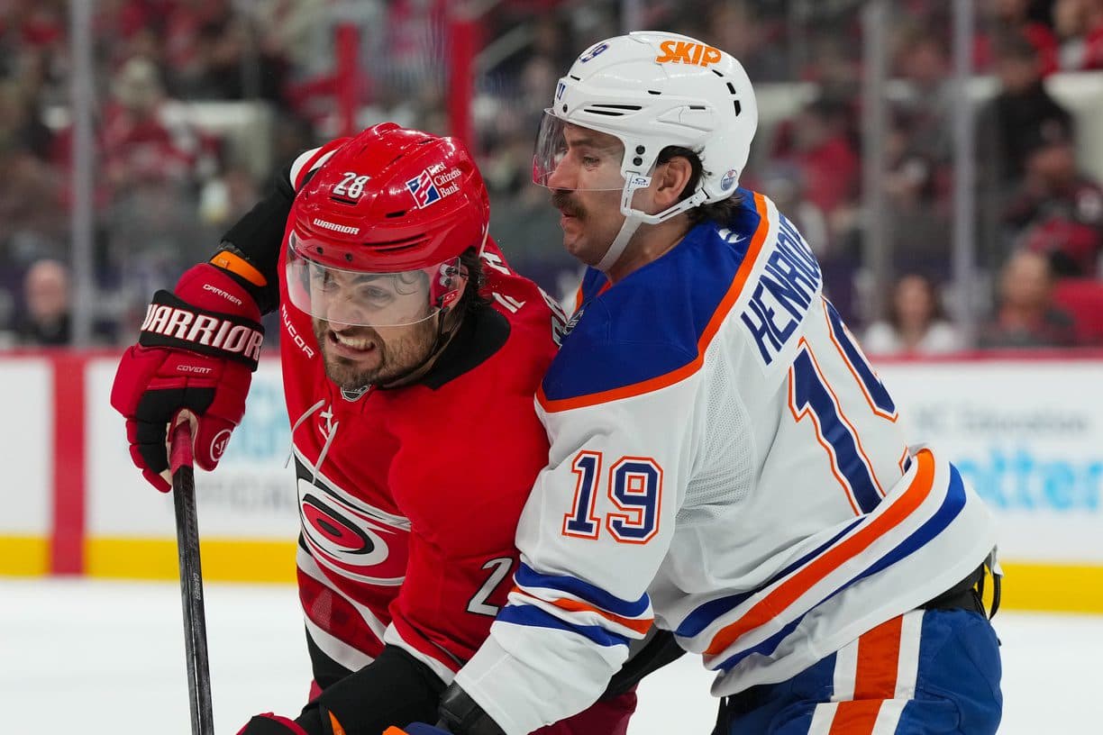 Carolina Hurricanes left wing William Carrier (28) and Edmonton Oilers center Adam Henrique (19) battle for position during the first period at Lenovo Center.