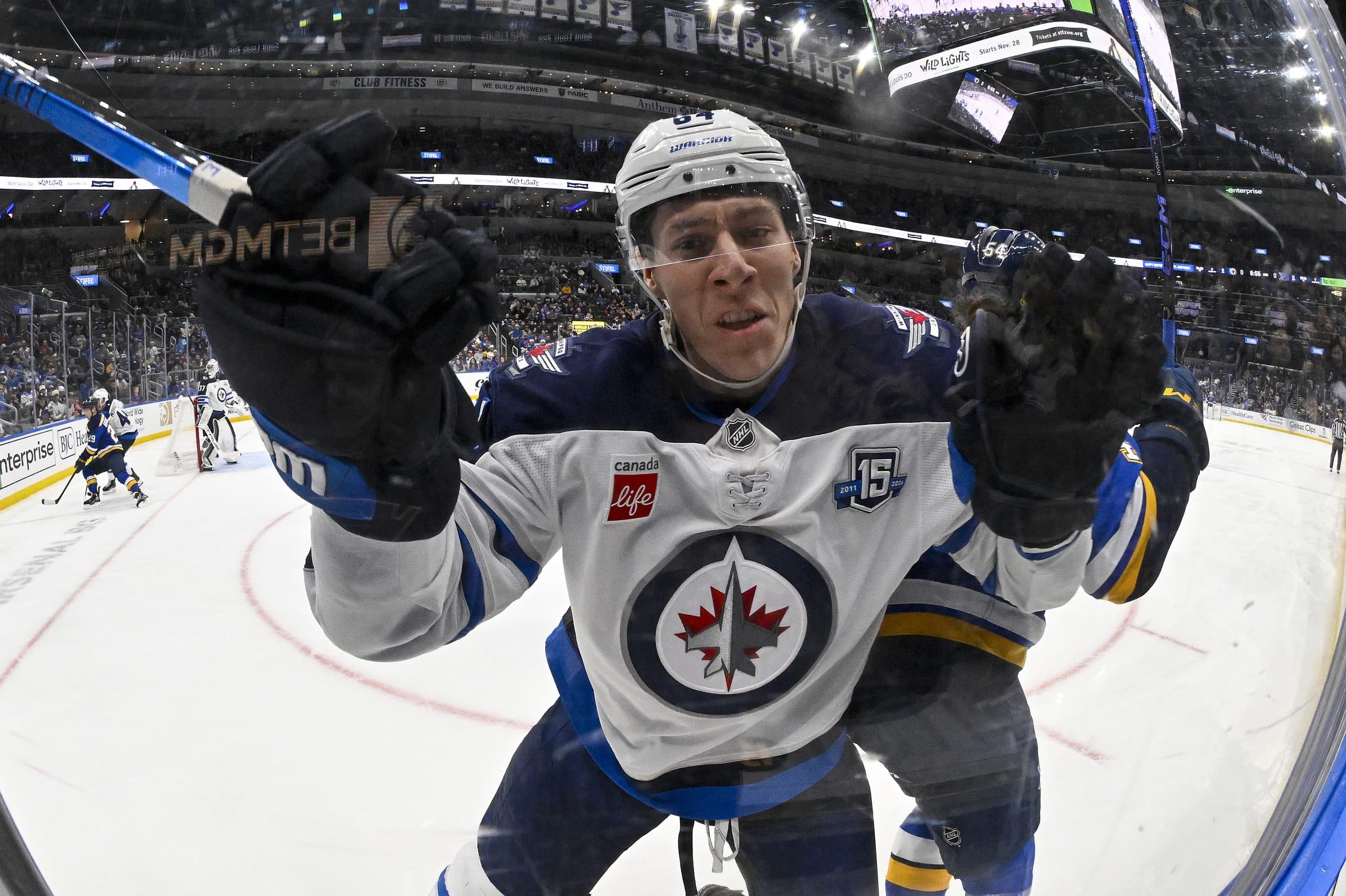 Winnipeg Jets defenseman Logan Stanley (64) slams in to the glass after missing a check on St. Louis Blues right wing Dalibor Dvorsky (54) during the second period at Enterprise Center.