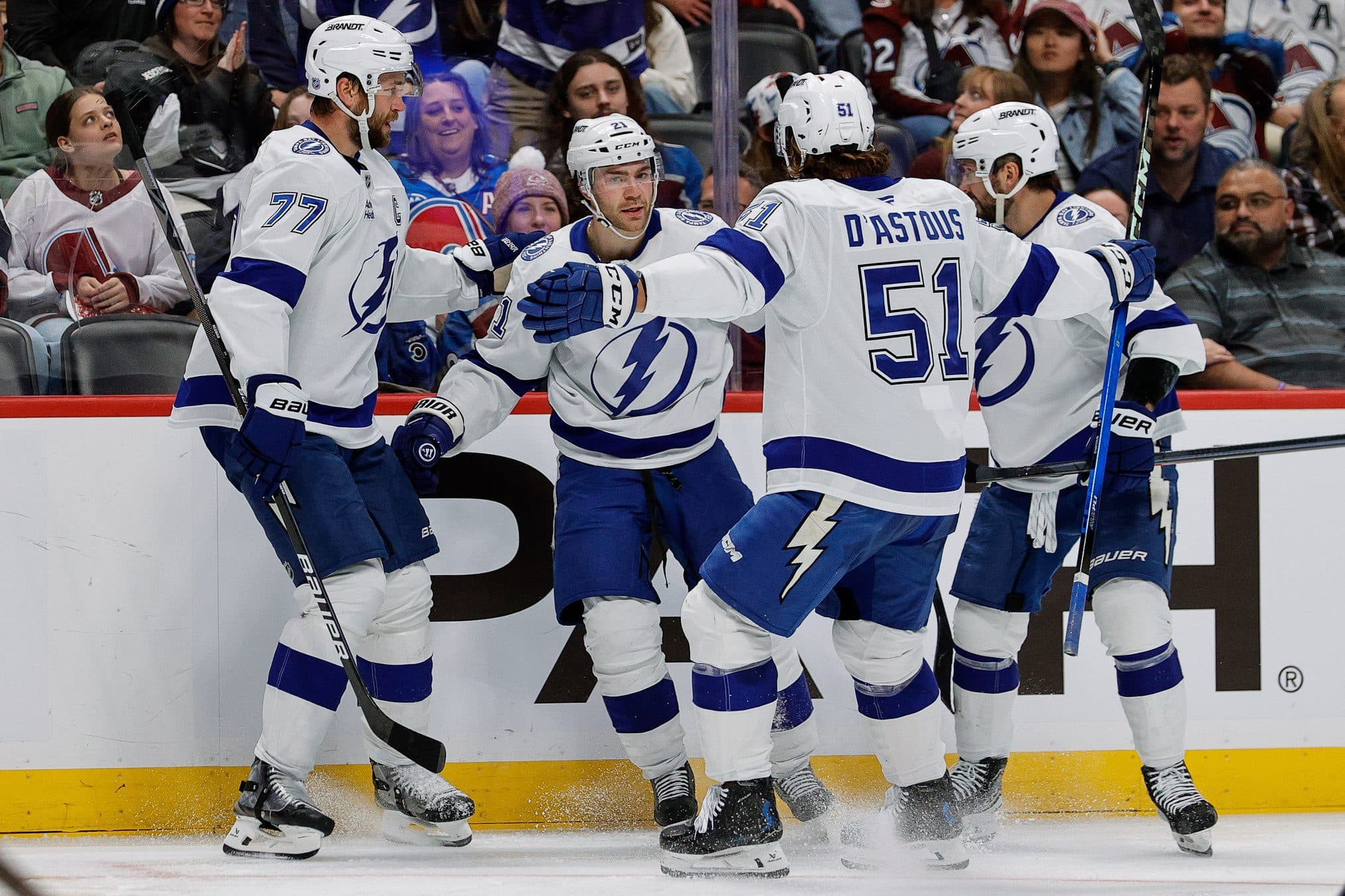 Tampa Bay Lightning center Brayden Point (21) celebrates his goal with defenseman Victor Hedman (77) and defenseman Charle-Edouard D'Astous (51) and right wing Nikita Kucherov (86) in the third period against the Colorado Avalanche at Ball Arena.