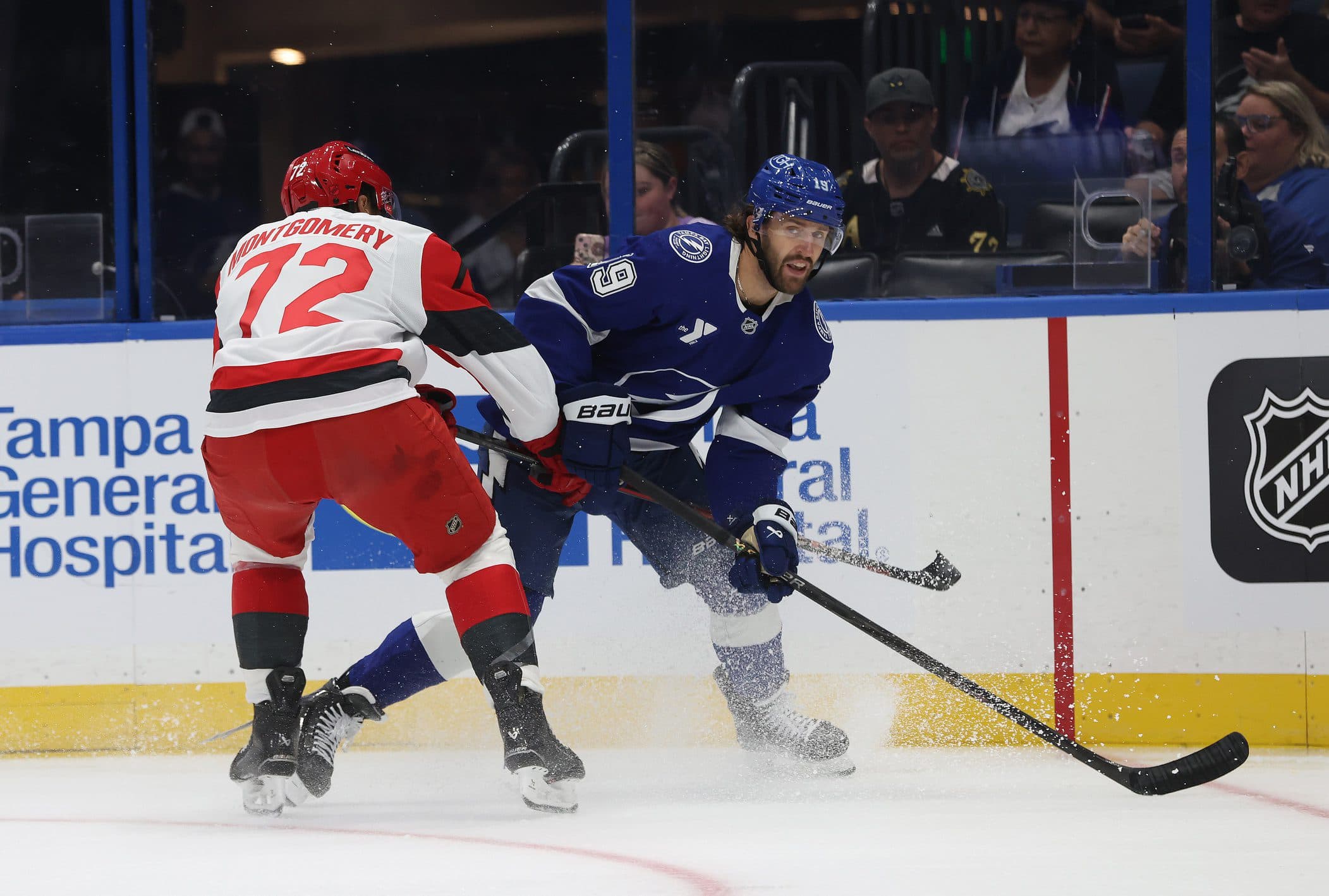 Tampa Bay Lightning left wing Wojciech Stachowiak (19) passes the puck as Carolina Hurricanes defenseman Bryce Montgomery (72) defends during the first period at Benchmark International Arena.