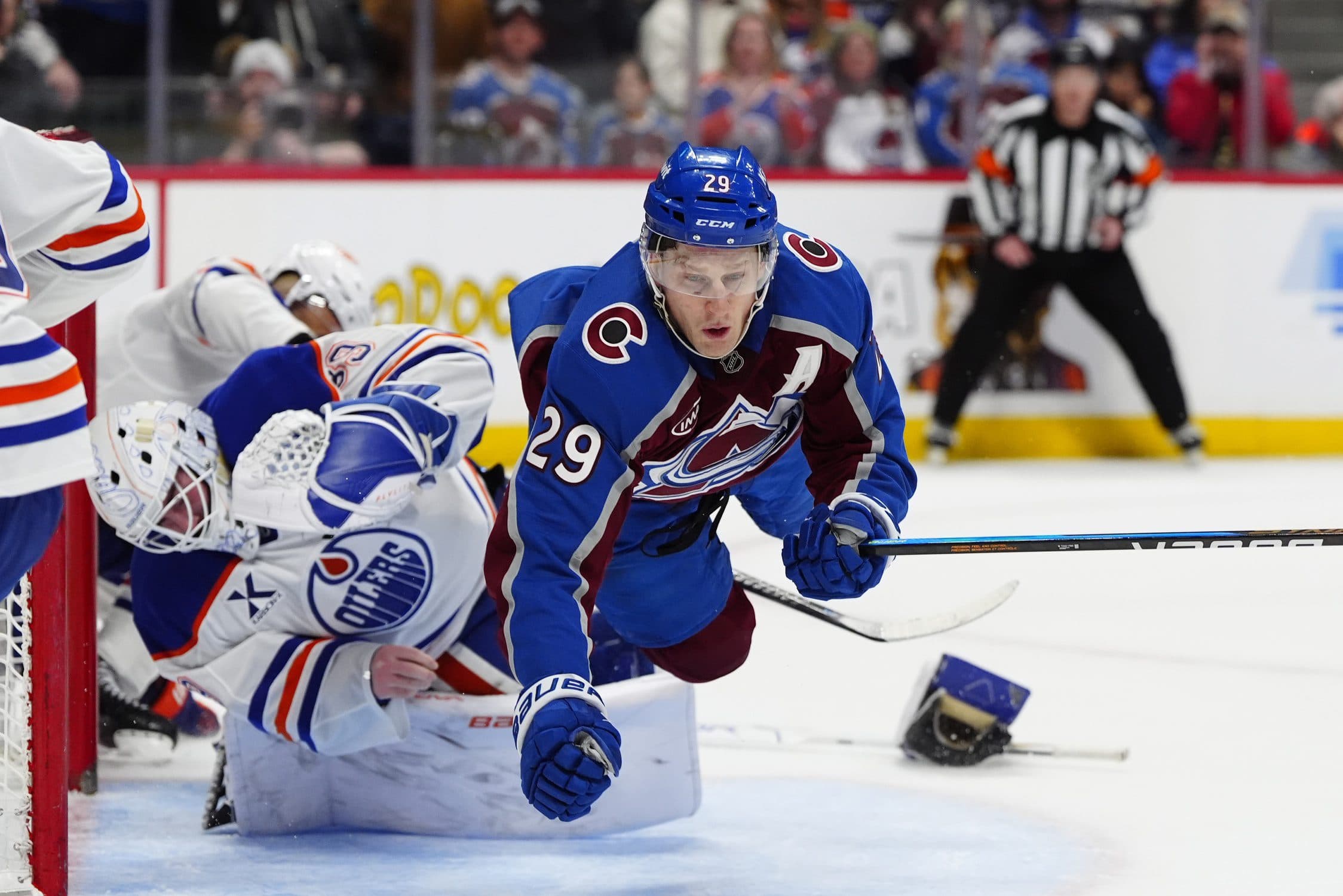Colorado Avalanche center Nathan MacKinnon (29) collides into Edmonton Oilers goaltender Connor Ingram (39) in the second period at Ball Arena.