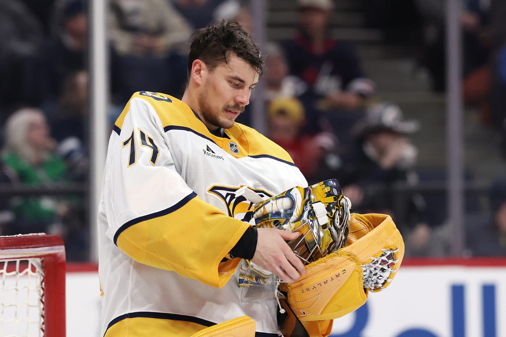 Nashville Predators goaltender Juuse Saros (74) adjusts his mask during a time out against the Winnipeg Jets in the second period at Canada Life Centre.