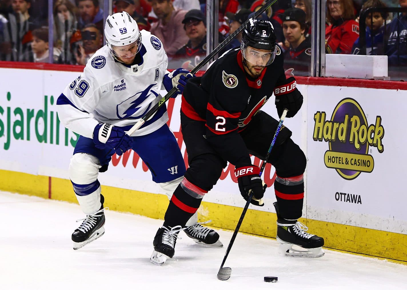 Ottawa Senators defenseman Artem Zub (2) and Tampa Bay Lightning center Jake Guentzel (59) vie for the puck during the second period at Canadian Tire Centre.