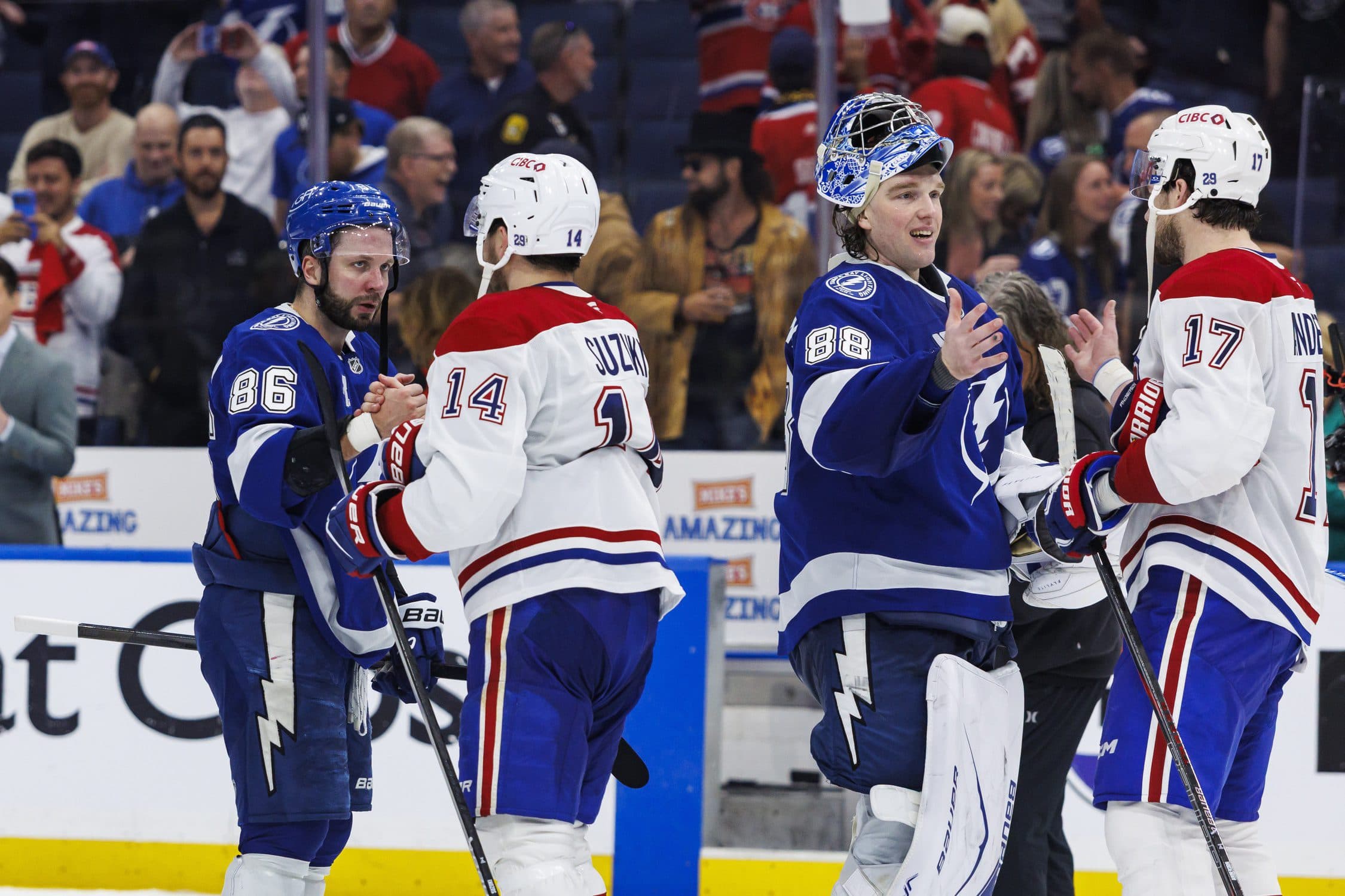 Tampa Bay Lightning forward Nikita Kucherov (86) and goalie Andrei Vasilevskiy (88) shake hands with Montreal Canadiens forward Nick Suzuki (14) and forward Josh Anderson (17) after game seven of the first round of the 2026 Stanley Cup Playoffs at Benchmark International Arena.