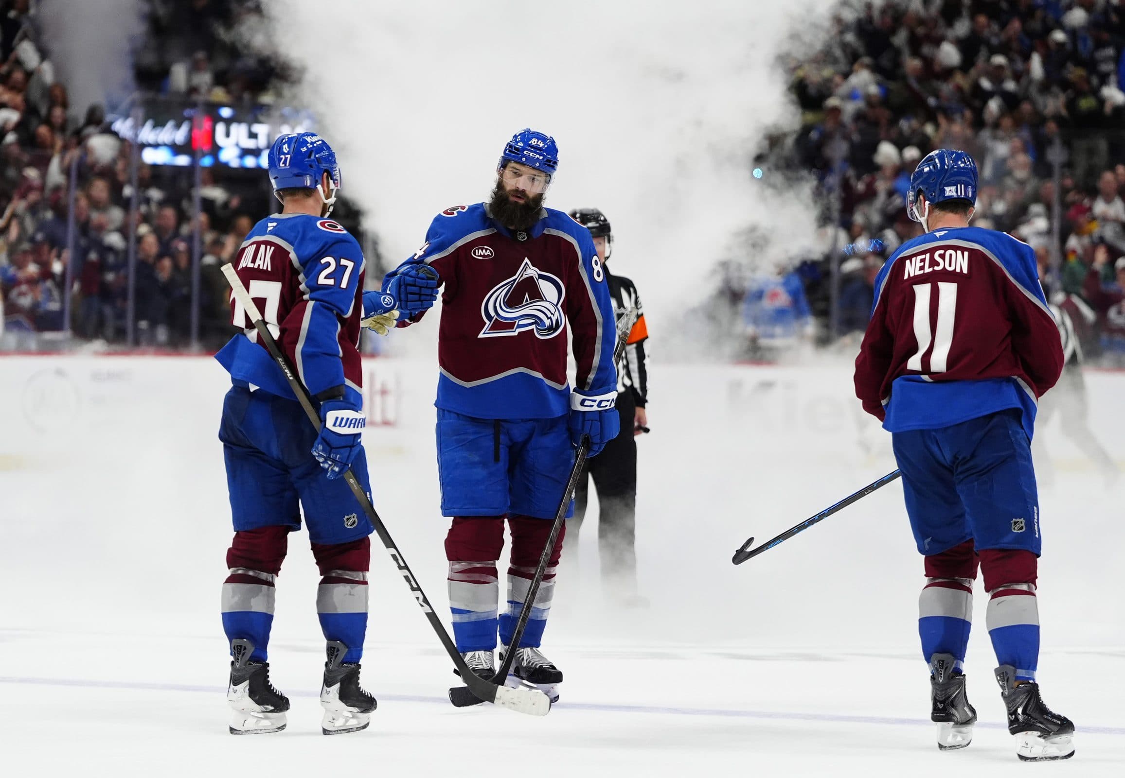 Colorado Avalanche defenseman Brett Kulak (27), defenseman Brent Burns (84) and center Brock Nelson (11) celebrate defeating the Minnesota Wild during the third period in game two of the second round of the 2026 Stanley Cup Playoffs at Ball Arena.