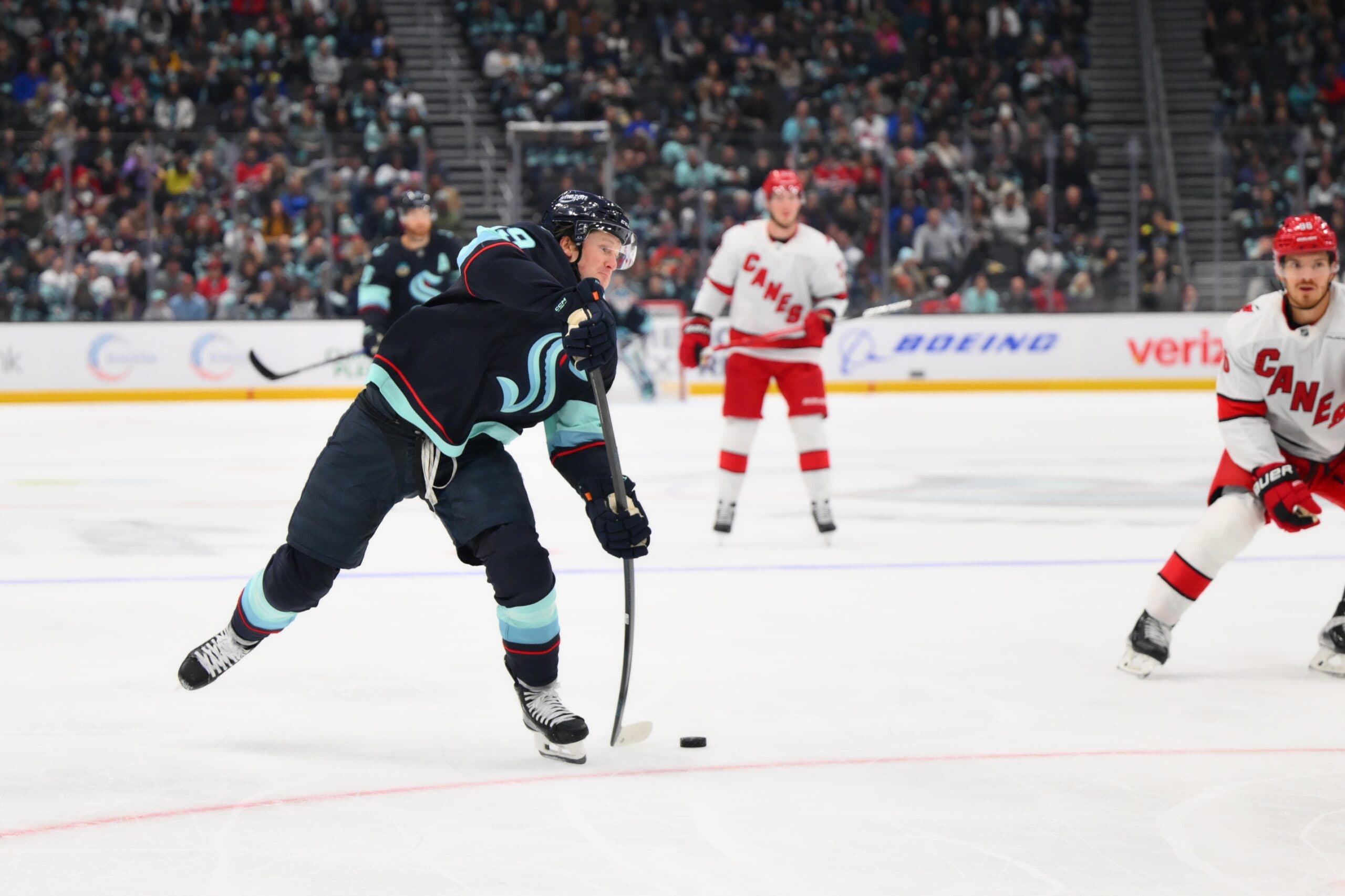 Seattle Kraken left wing Jared McCann (19) shoots the puck against the Carolina Hurricanes during the first period at Climate Pledge Arena.