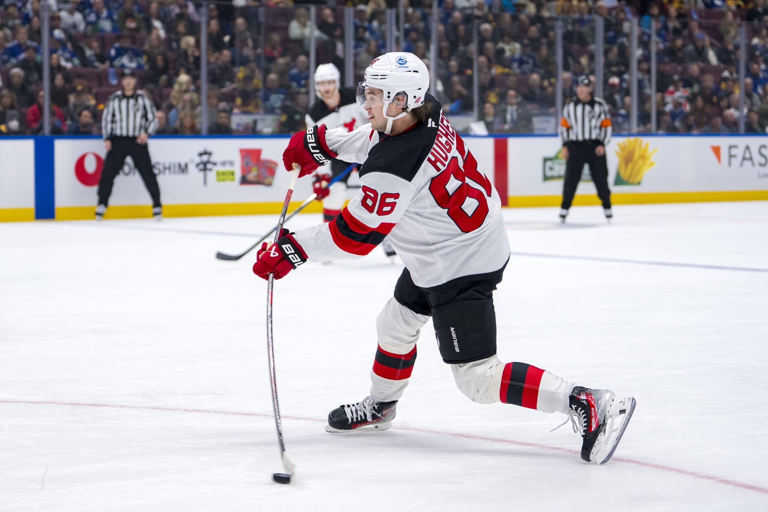 New Jersey Devils forward Jack Hughes (86) shoots against the Vancouver Canucks during the first period at Rogers Arena