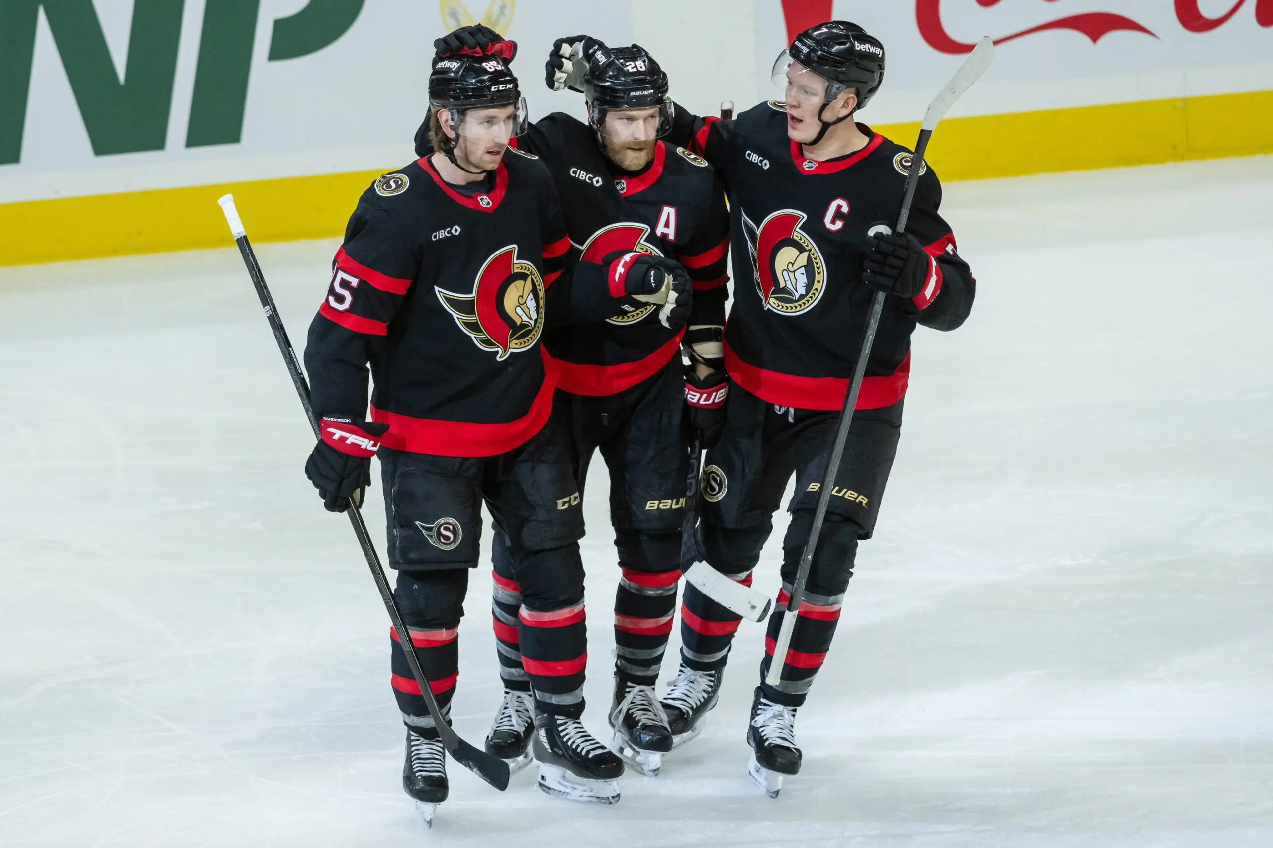 Ottawa Senators defenseman Jake Sanderson (85) is celebrated by right wing Claude Giroux (28) and left wing Brady Tkachuk (7) for his goal scored in the third period against the Washington Capitals at the Canadian Tire Centre