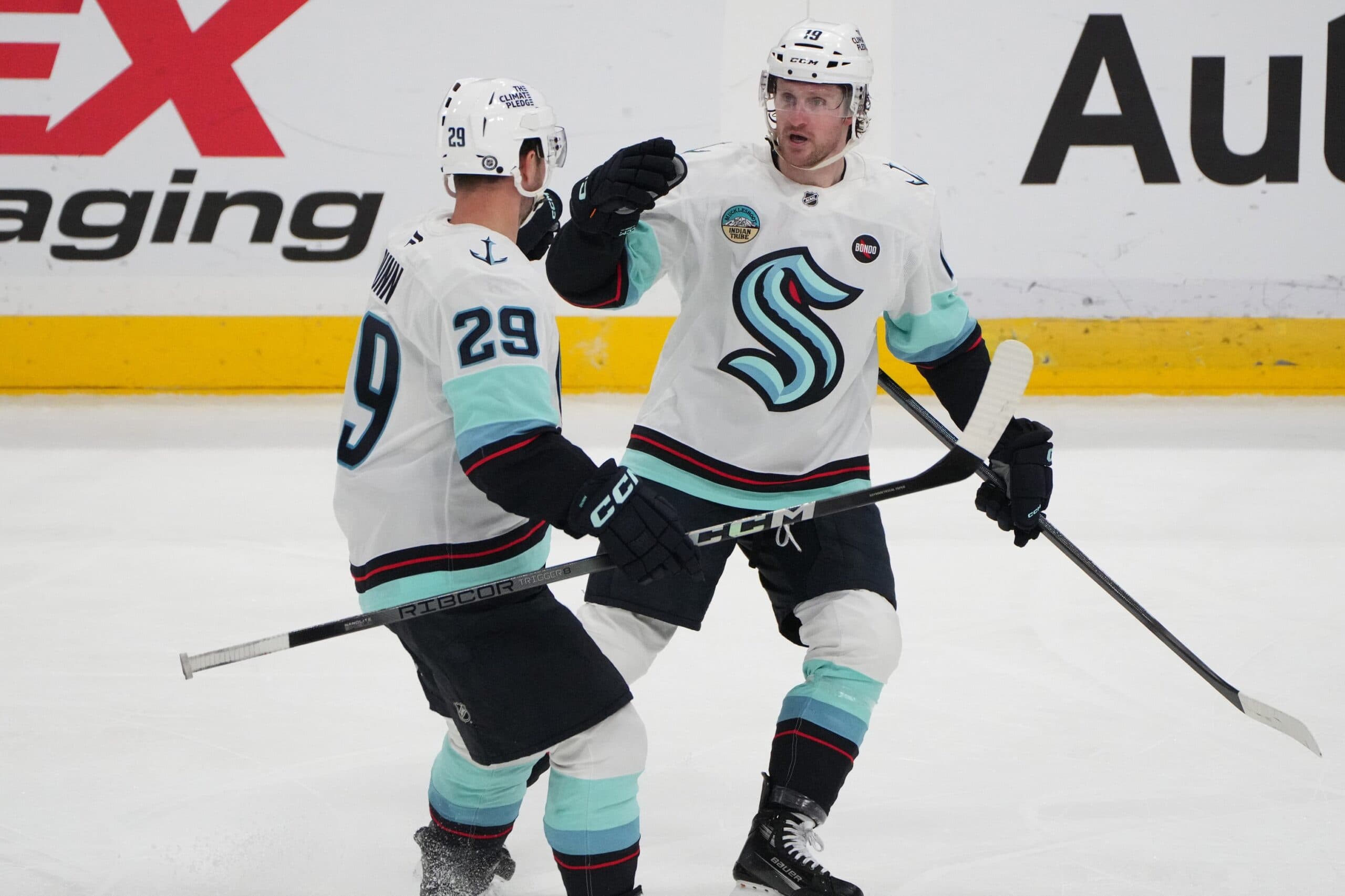 Seattle Kraken left wing Jared McCann (19) celebrates his goal against the Florida Panthers with teammate Vince Dunn (29) during the third period at Amerant Bank Arena.