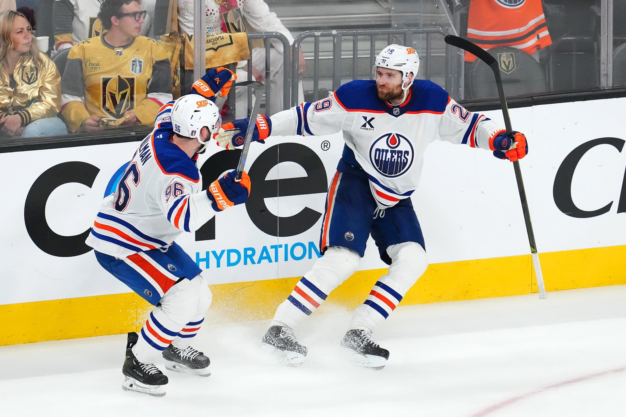 Edmonton Oilers center Leon Draisaitl (29) celebrates with defenseman Jake Walman (96) after scoring a game-winning goal against the Vegas Golden Knights during an overtime period of game two of the second round of the 2025 Stanley Cup Playoffs at T-Mobile Arena.