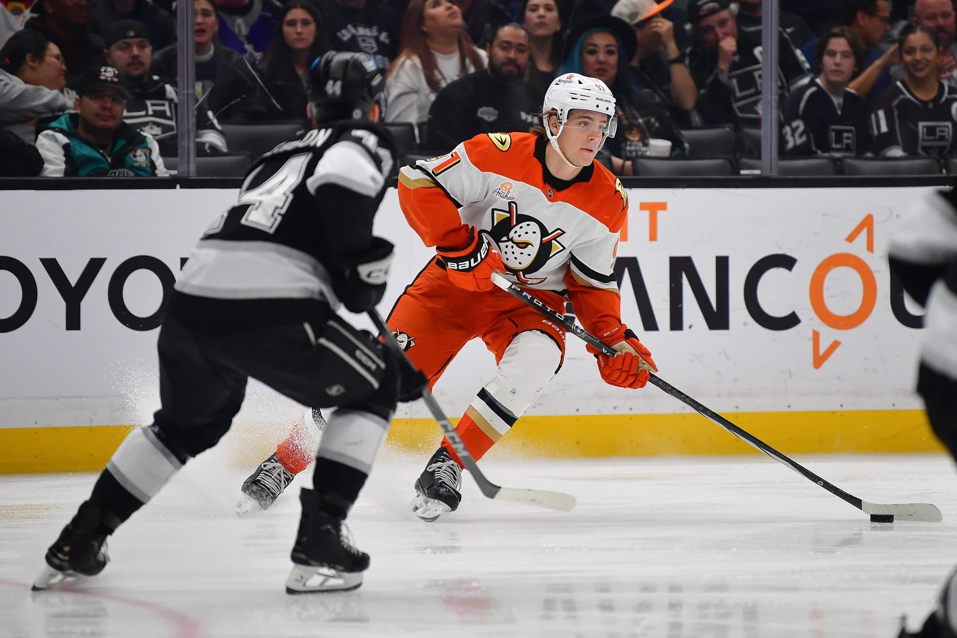 Anaheim Ducks center Leo Carlsson (91) moves the puck against Los Angeles Kings defenseman Mikey Anderson (44) during the third period at Crypto.com Arena.