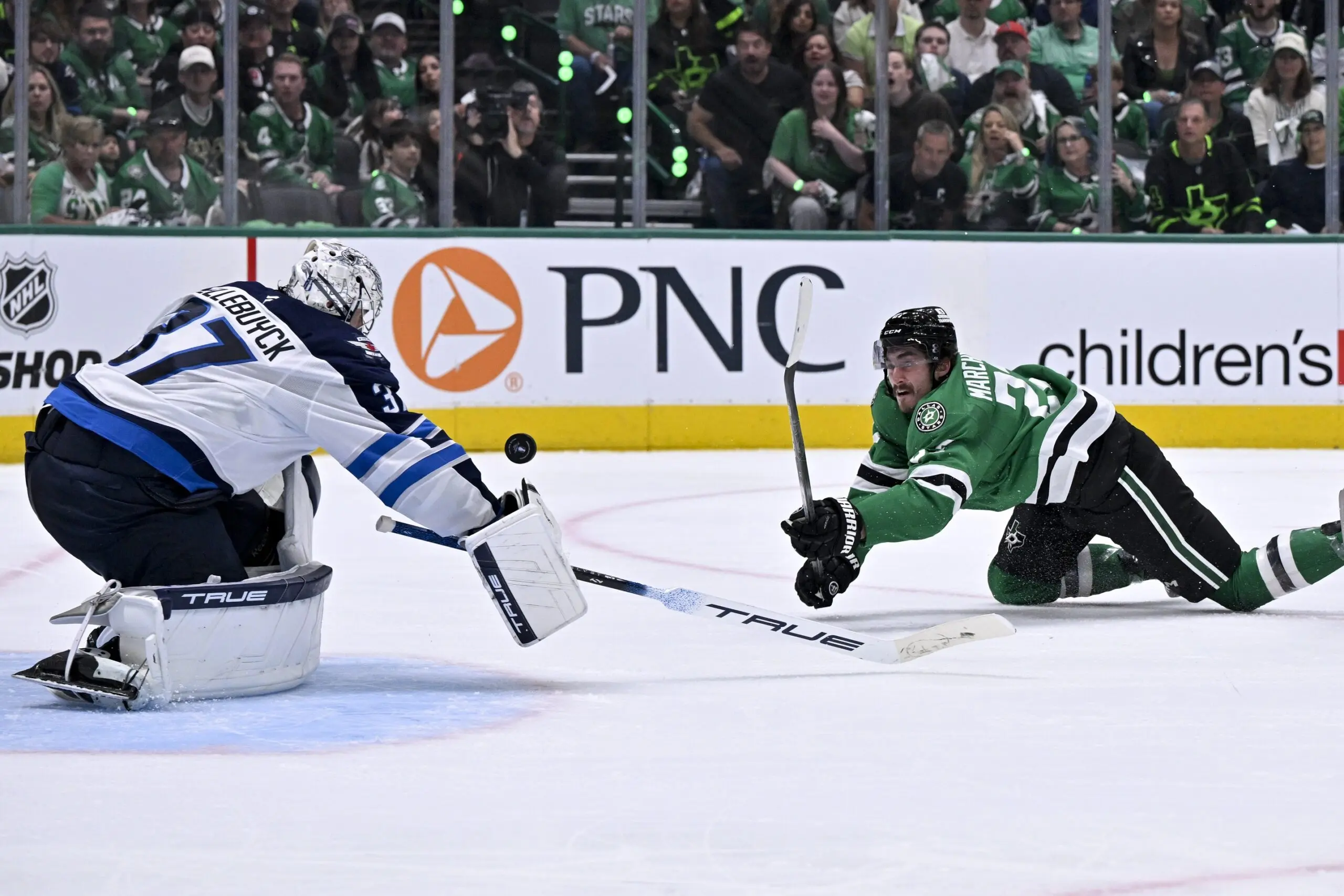 Winnipeg Jets goaltender Connor Hellebuyck (37) and Dallas Stars left wing Mason Marchment (27) in action during the game between the Dallas Stars and the Winnipeg Jets in game three of the second round of the 2025 Stanley Cup Playoffs at American Airlines Center.