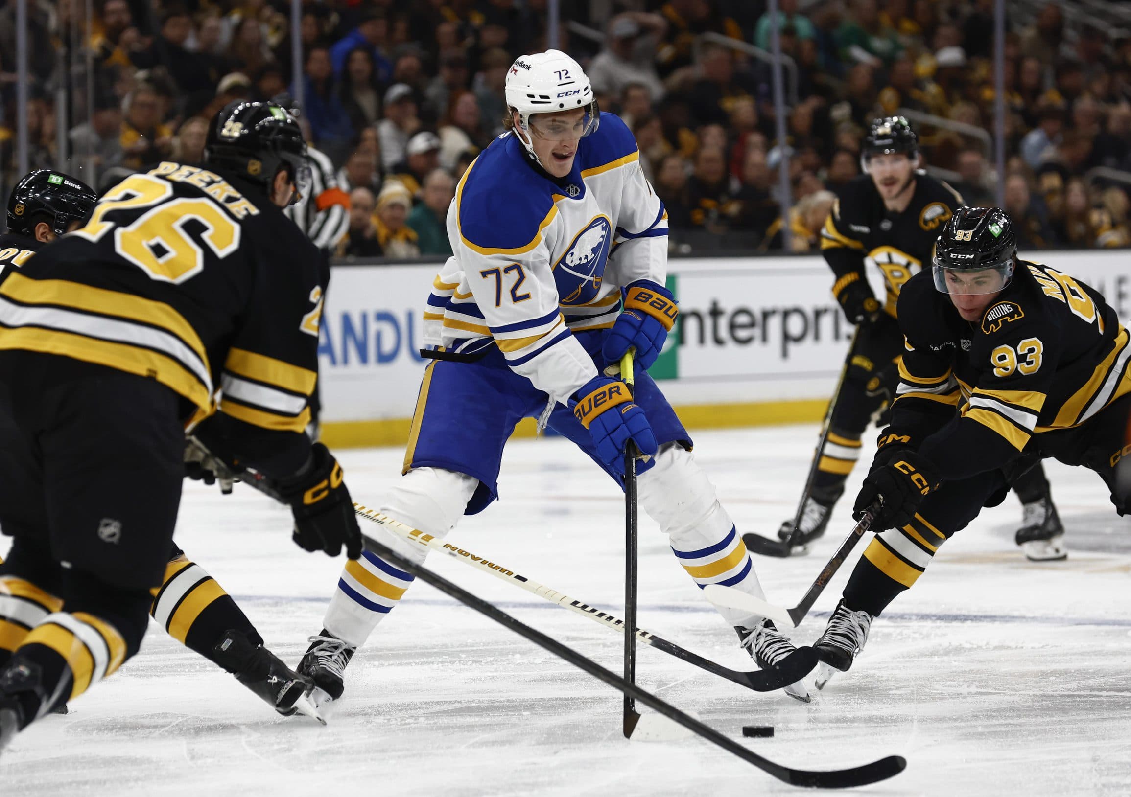 Buffalo Sabres center Tage Thompson (72) tries to go between Boston Bruins center Fraser Minten (93) and defenseman Andrew Peeke (26) during the second period at TD Garden