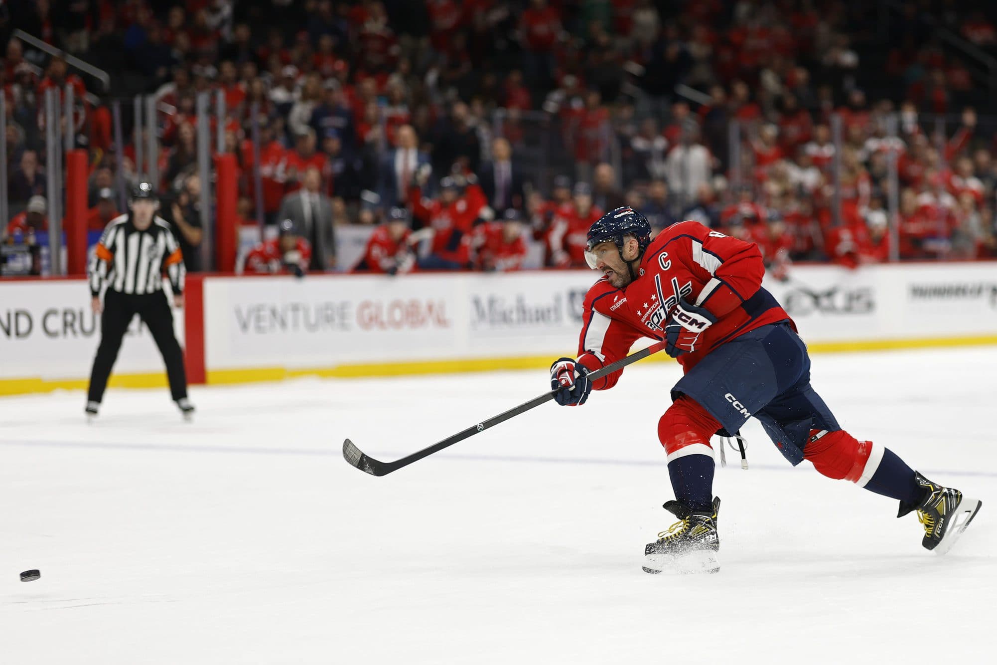 Washington Capitals left wing Alex Ovechkin (8) shoots the puck against the Vancouver Canucks during the third period at Capital One Arena.