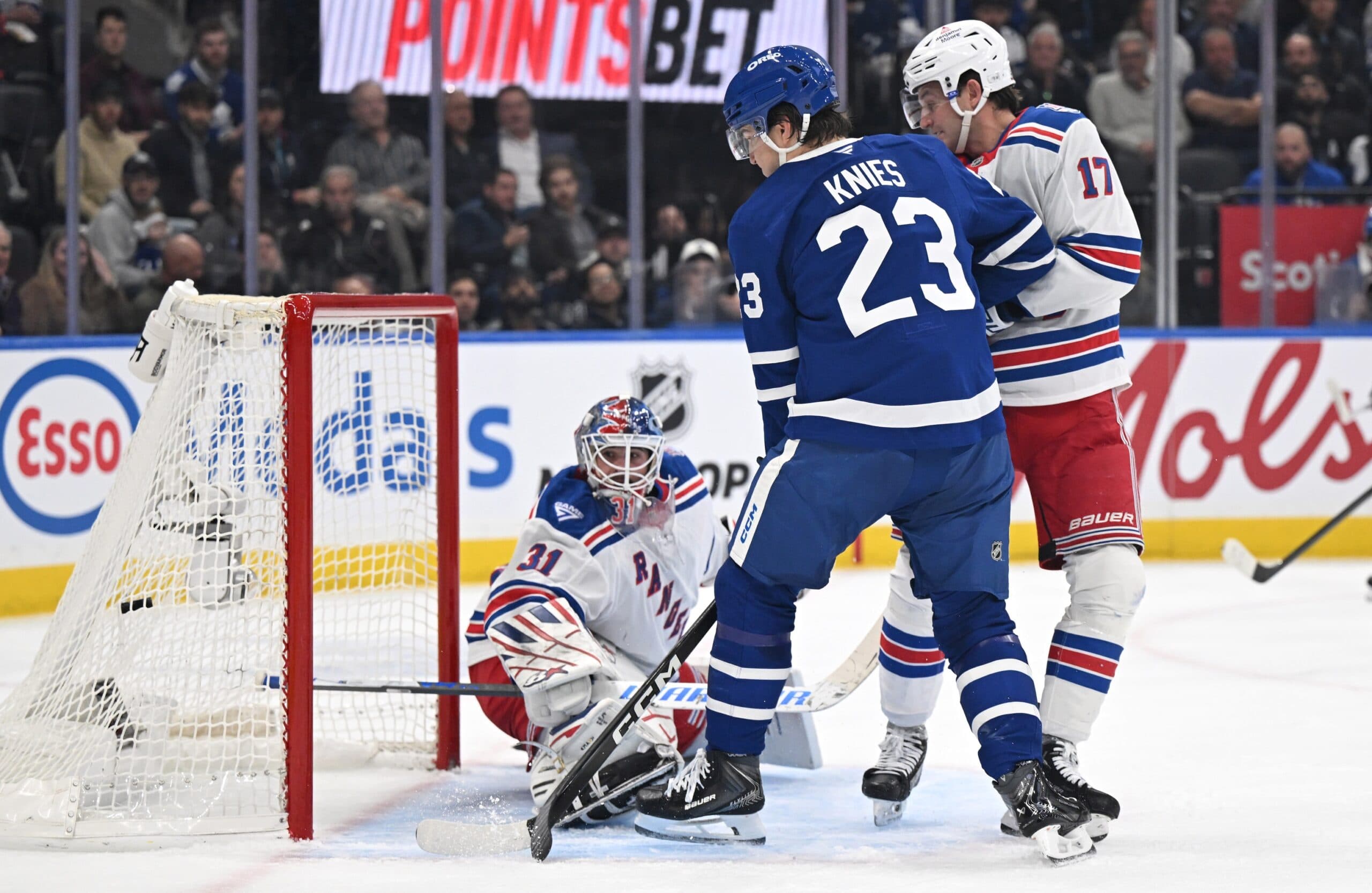 Toronto Maple Leafs forward Matthew Knies (23) scores a goal against New York Rangers goalie Igor Shesterkin (31) and defenseman Will Borgen (17) in the first period at Scotiabank Arena.