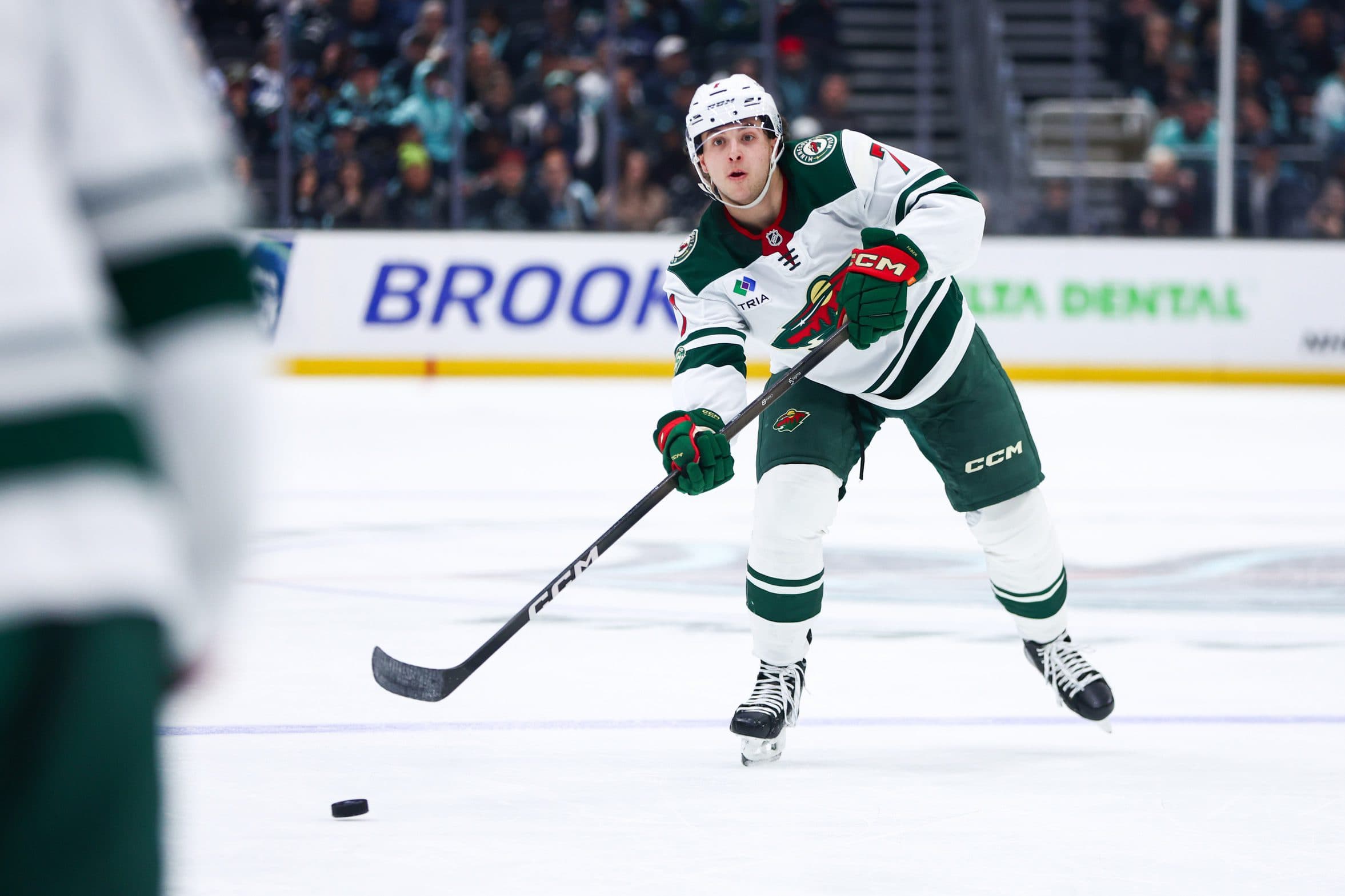 Minnesota Wild defenseman Brock Faber (7) passes the puck during the first period against the Seattle Kraken at Climate Pledge Arena.