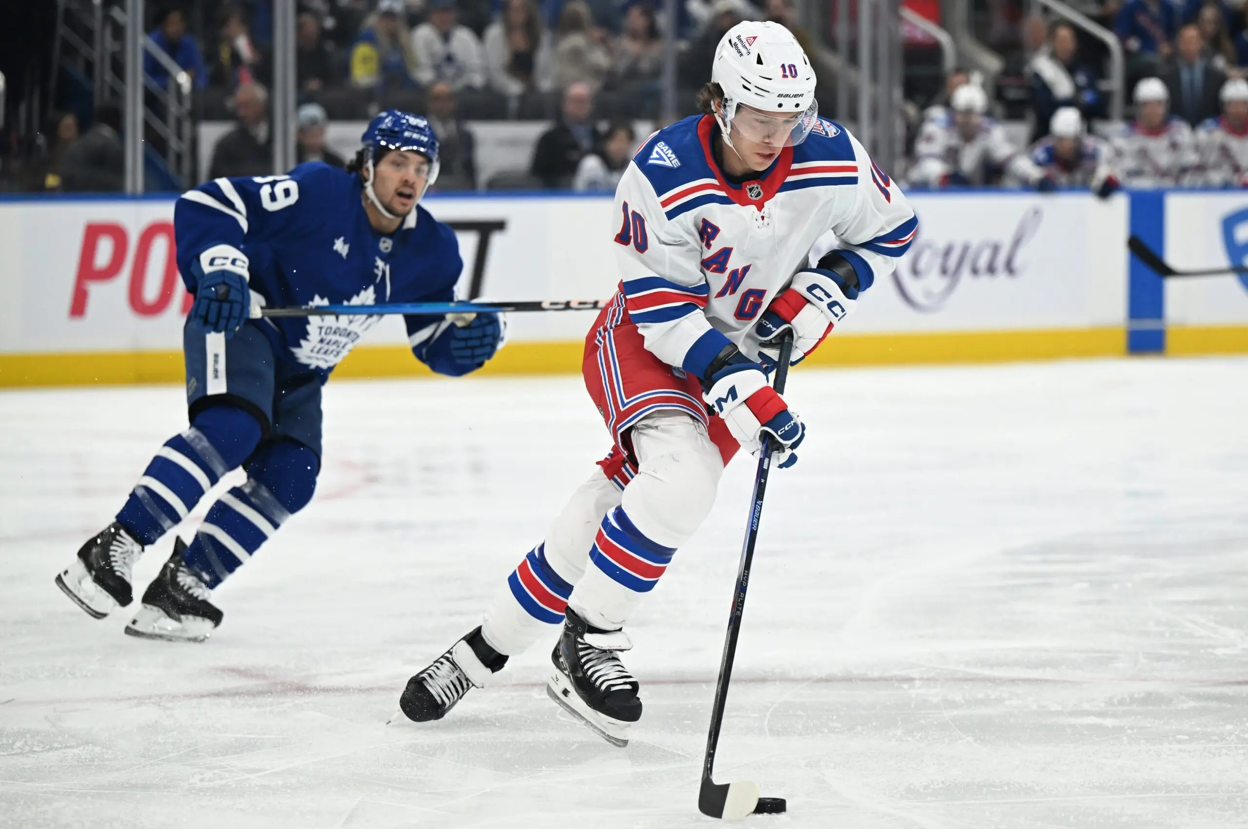 New York Rangers forward Artemi Panarin (10) skates the puck away from Toronto Maple Leafs forward Nick Robertson (89) in the first period at Scotiabank Arena.