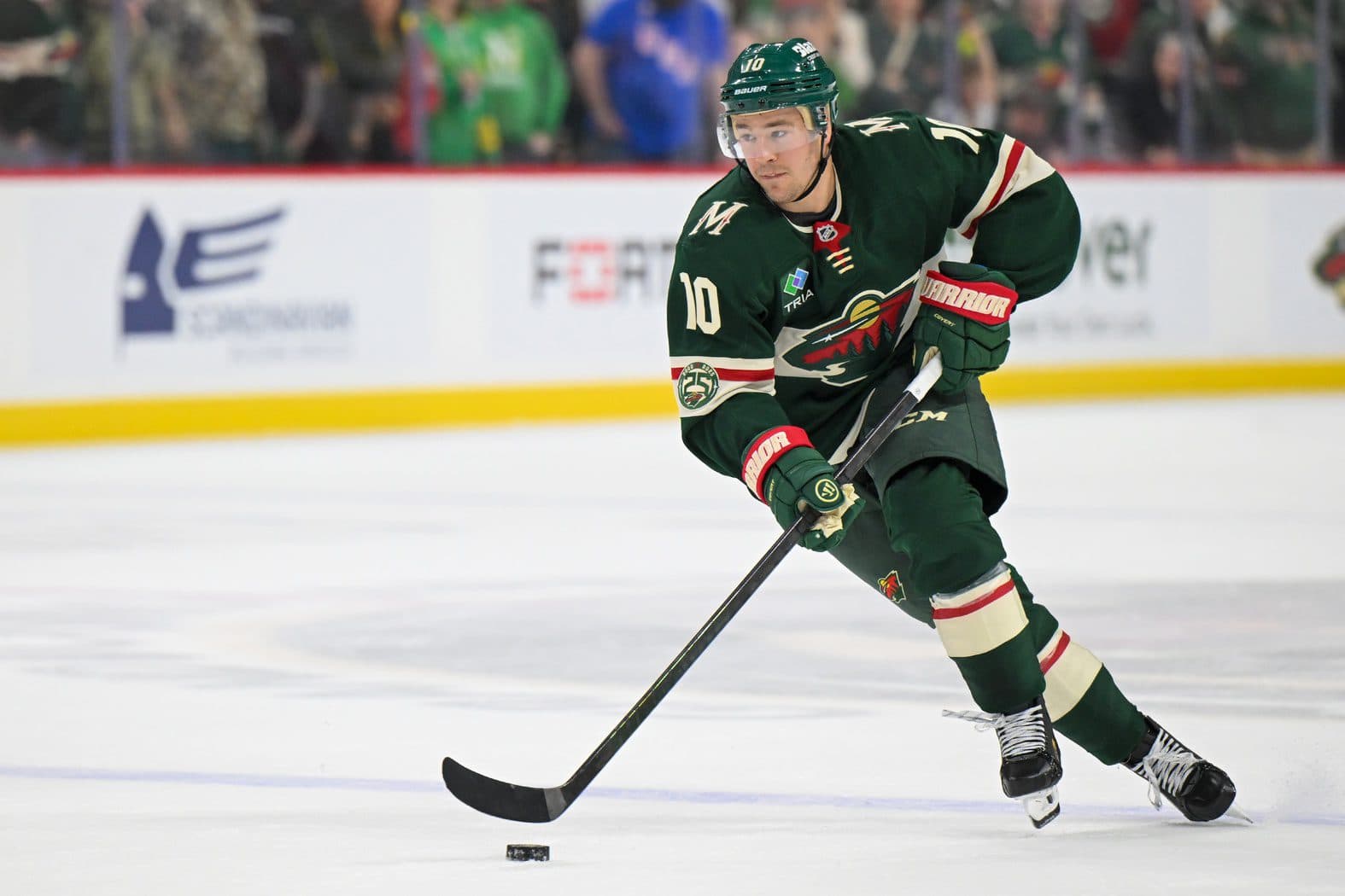 Minnesota Wild forward Bobby Brink (10) controls the puck against the Dallas Stars in overtime at Grand Casino Arena.