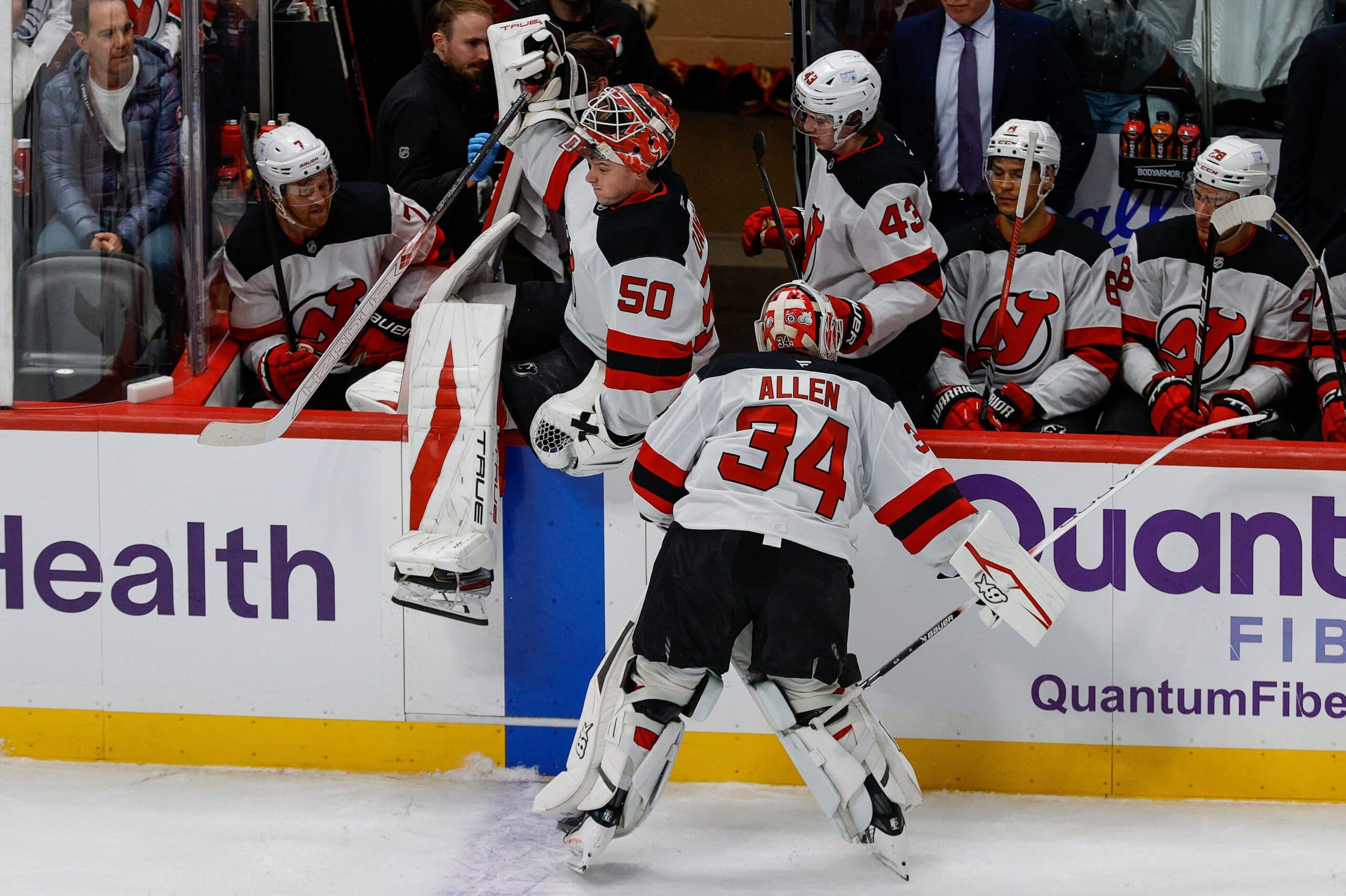 New Jersey Devils goaltender Jake Allen (34) slams his stick into the boards as he is replaced by goaltender Nico Daws (50) in the third period against the Colorado Avalanche at Ball Arena.