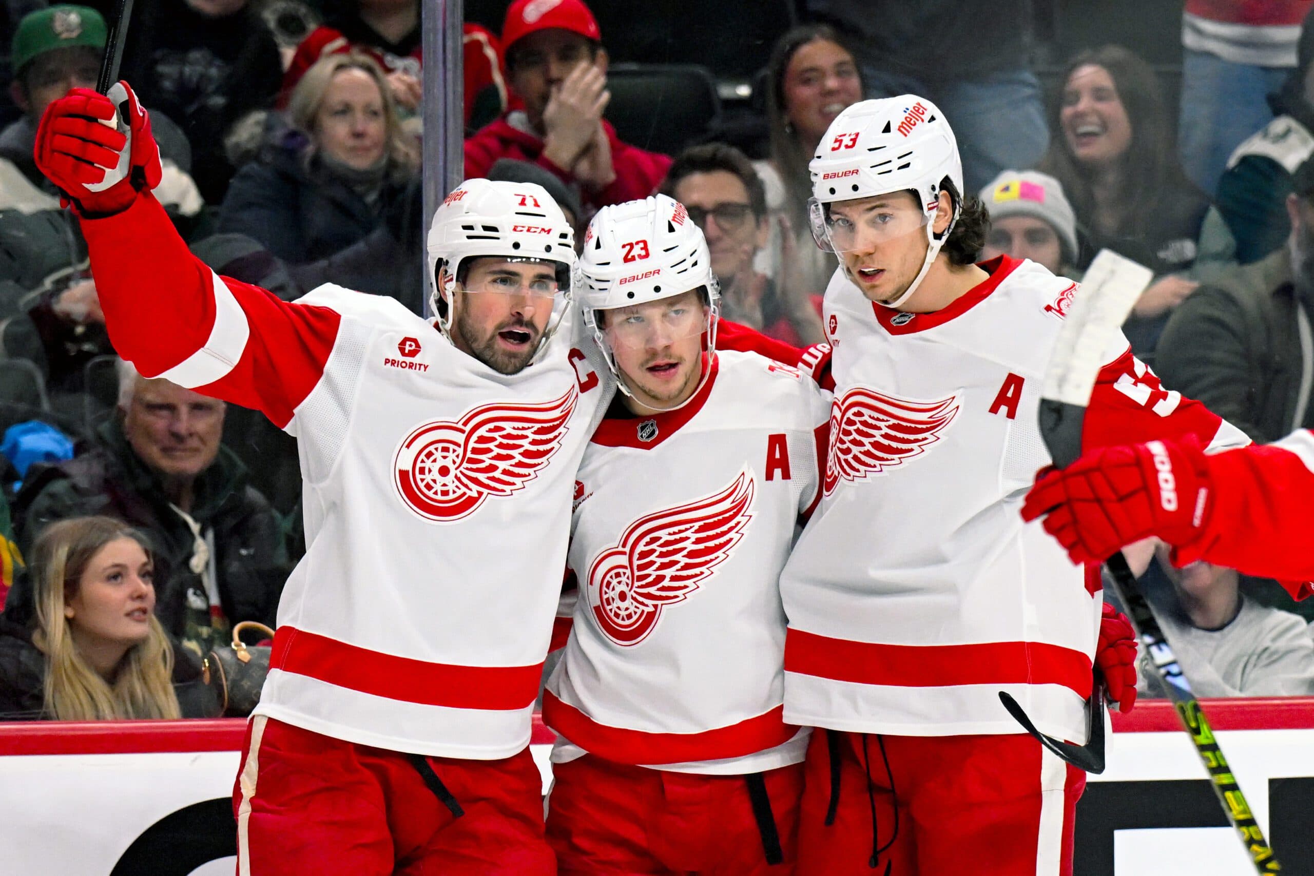 Detroit Red Wings forward Lucas Raymond (23) celebrates his power play goal against the Minnesota Wild with forward Dylan Larkin (71) and defensemen Moritz Seider (53) during the first period at Grand Casino Arena.