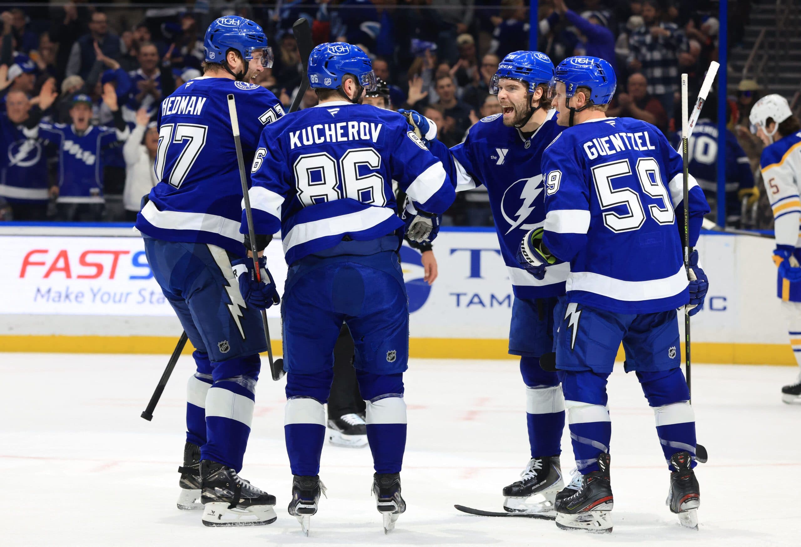 Tampa Bay Lightning right wing Nikita Kucherov (86) is congratulated by left wing Brandon Hagel (38), defenseman Victor Hedman (77) and center Jake Guentzel (59) after he scored a goal against the Buffalo Sabres during the first period at Benchmark International Arena.