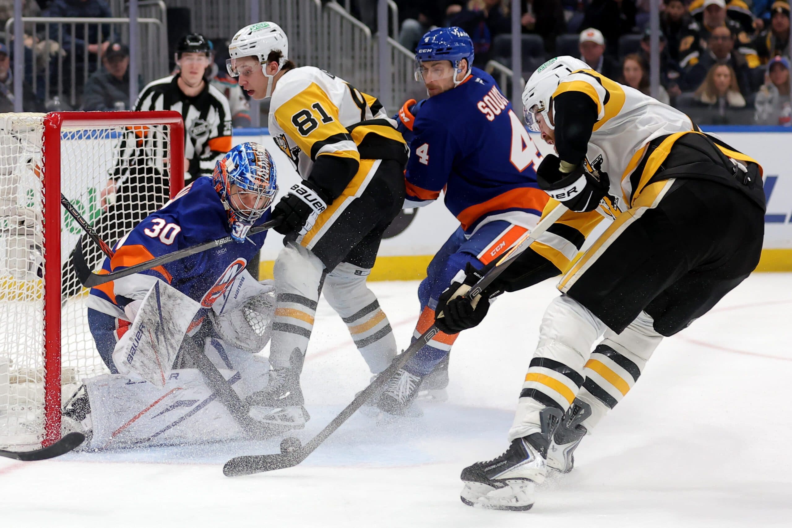 Pittsburgh Penguins right wing Justin Brazeau (16) shoots the puck against New York Islanders goaltender Ilya Sorokin (30) and defenseman Carson Soucy (4) in front of Penguins center Ben Kindel (81) during the third period at UBS Arena.