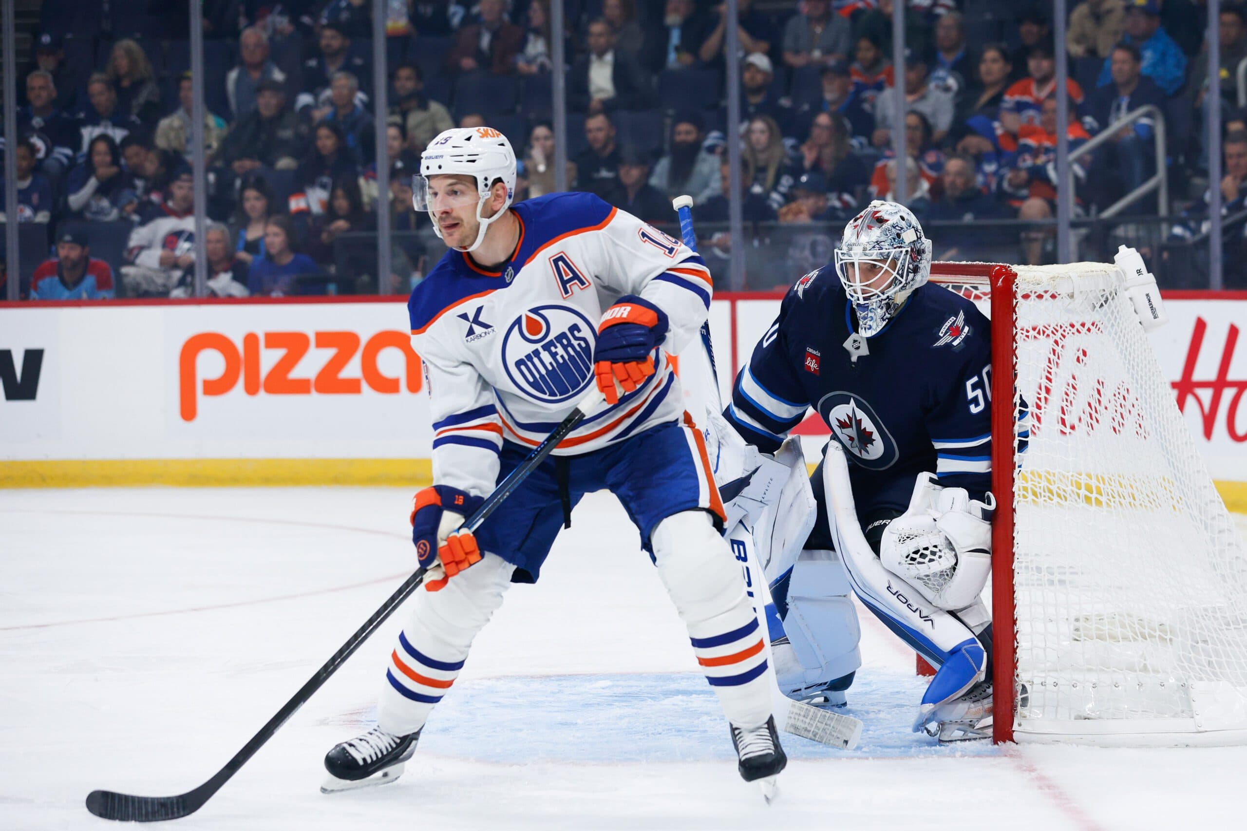 Edmonton Oilers forward Zach Hyman (18) screens Winnipeg Jets goalie Domenic DiVincentiis (50) during the first period at Canada Life Centre.