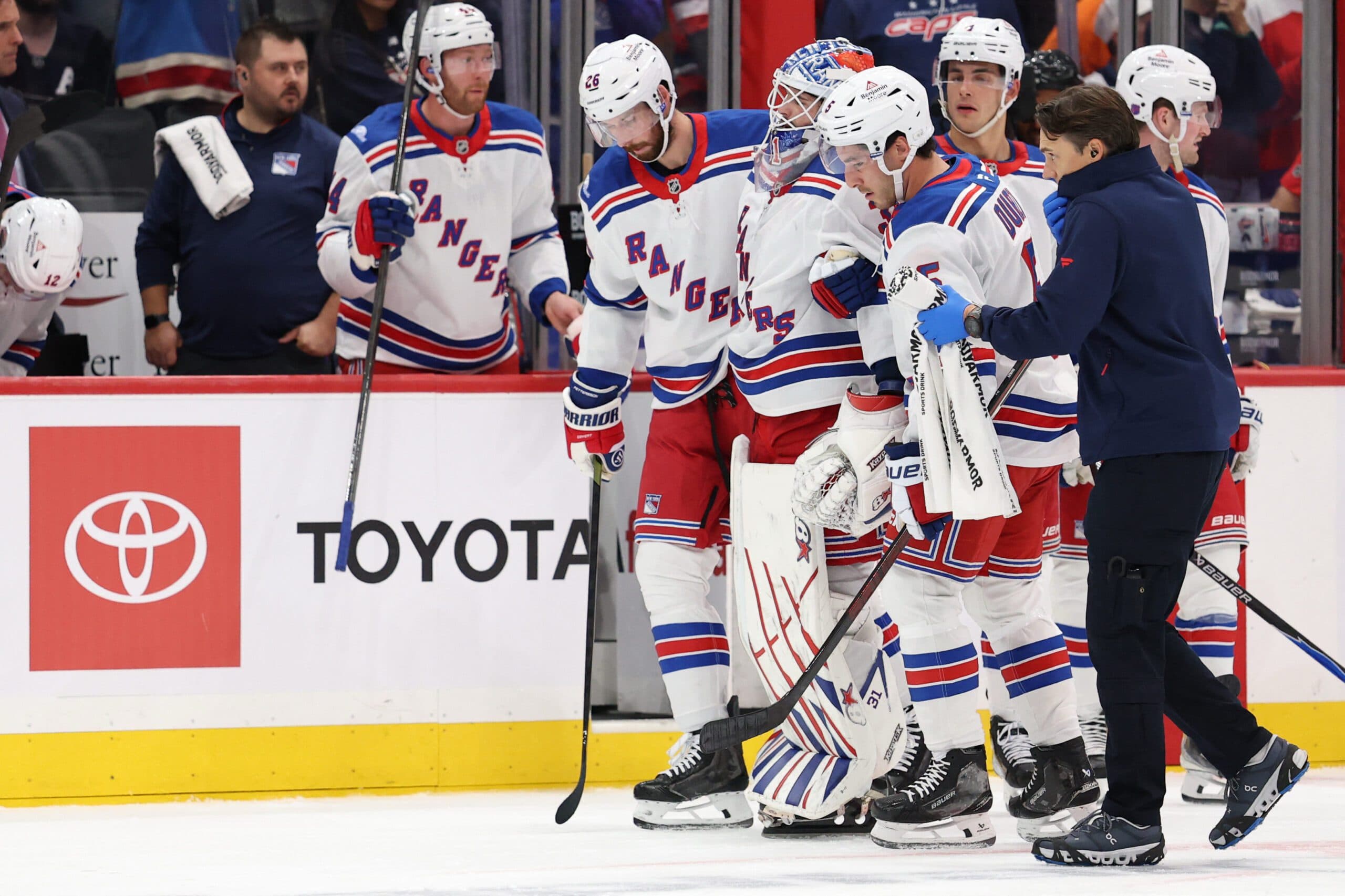 New York Rangers goaltender Igor Shesterkin (31) is helped off the ice after being injured against the Washington Capitals during the second period at Capital One Arena.