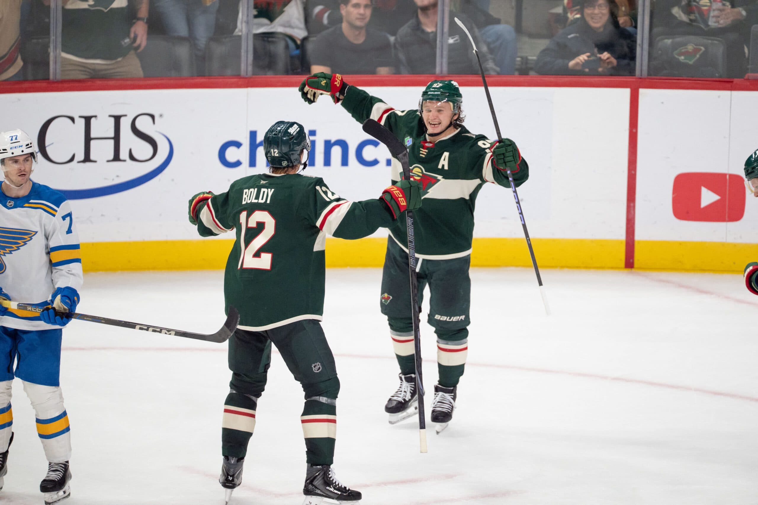 Minnesota Wild left wing Kirill Kaprizov (97) congratulates left wing Matt Boldy (12) on scoring a hat trick against the St. Louis Blues in the second period at Grand Casino Arena.